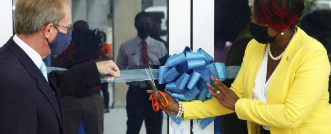 Alison Browne-Ellis, CEO, Cave Shepherd Card (Barbados) Inc. assisted by Roger Cave, Investment Director, Fortress Fund Managers & Cave Shepherd Board Member, cutting the ribbon to officially open the One + Haggatt Hall location of Payce Digital